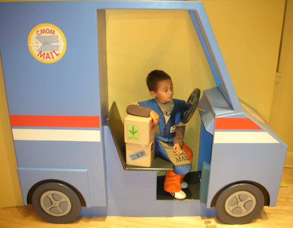 Child playing at an indoor museum exhibit